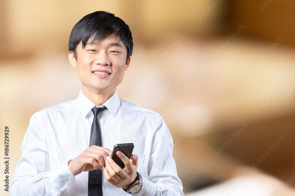 Asian businessman talking on mobile cell phone Asian businessman talking on mobile cell phone