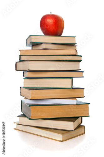 Book tower with apple isolated on white