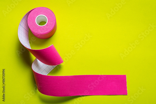 Kinesiology tape on colored background photo