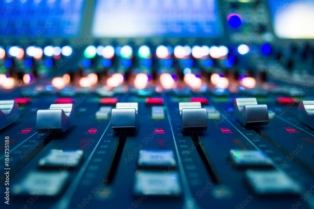 detail of a music mixer in studio dj working for new tracks music production with editing tools