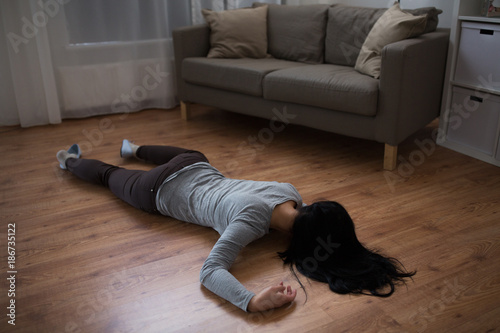 dead woman body lying on floor at crime scene photo
