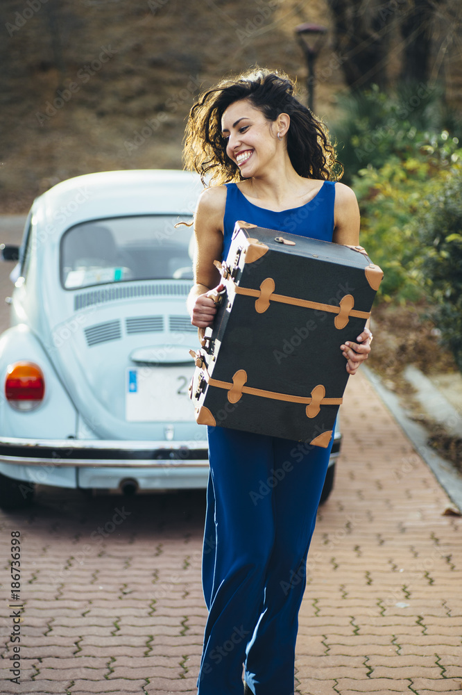 Obraz premium beautiful woman with suitcase and car