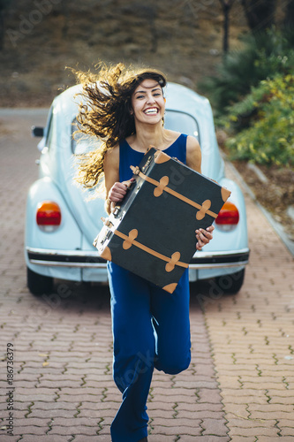 beautiful woman with suitcase and car