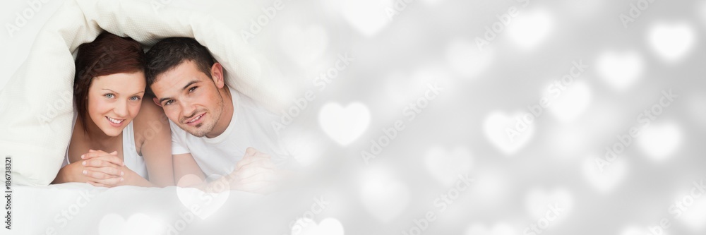 Couple under duvet with valentine's love transition hearts Couple under duvet with valentine's love transition hearts