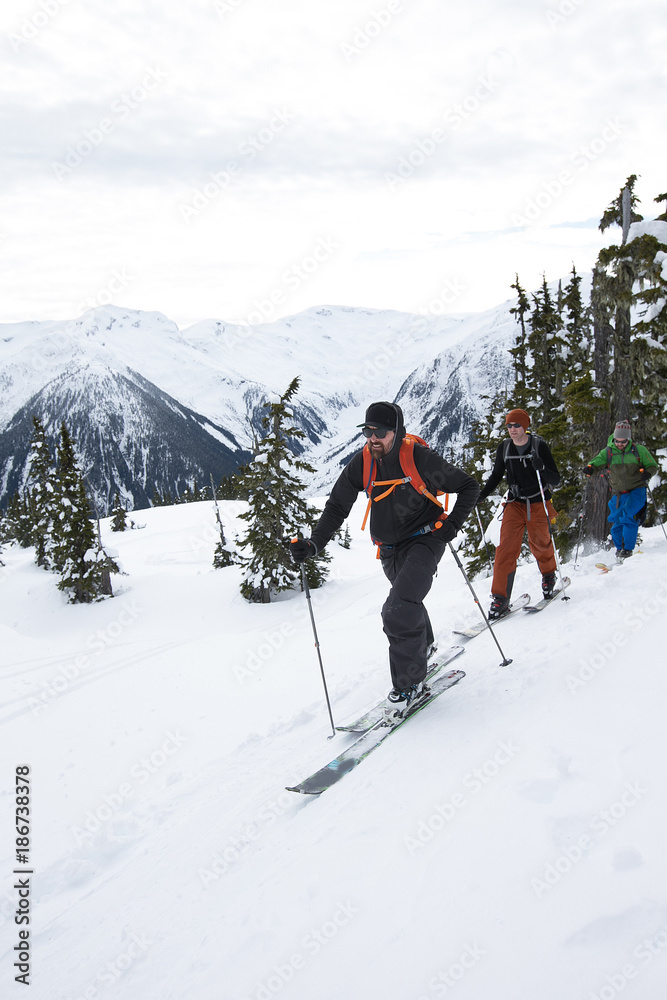 Young men ski touring in the mountains