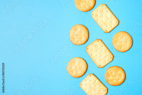 Crackers on solid light blue color background with copy space photo