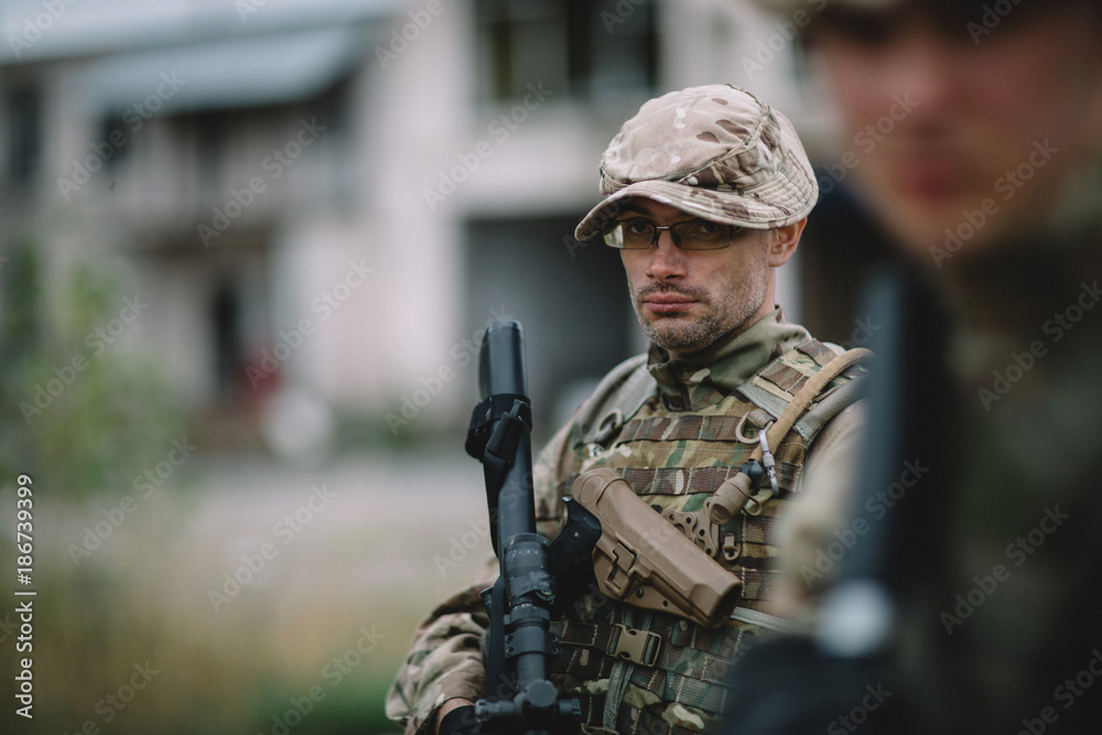 Army soldier during the military operation in the city. war, army, technology and people concept.
