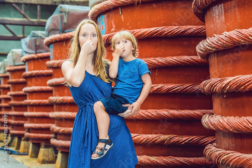 mom and son travelers shows how stinks fish sauce on Phu Quoc, Vietnam photo