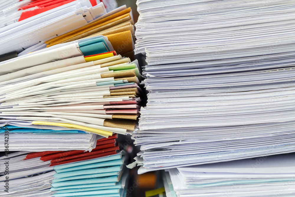 Close up of business papers stack on desk. Pile of unfinished documents on office desk Close up of business papers stack on desk. Pile of unfinished documents on office desk