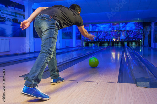 man throws bowling ball, blurred focus