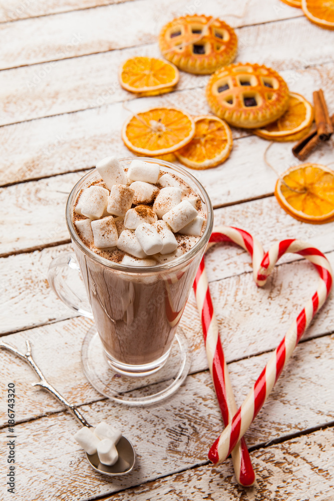 Fototapeta premium Hot cocoa with marshmallow on white rustic background. Top view