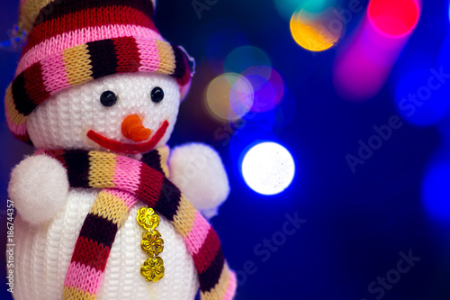 Toy snowman on the background of a festive New Year's background