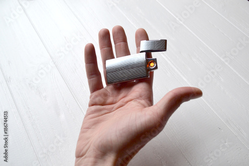 Man holding a usb lighter in his hands. photo