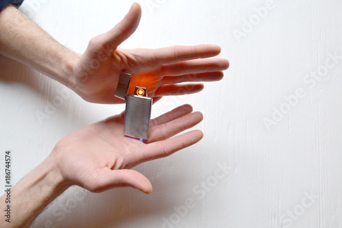 Man holding a usb lighter in his hands.