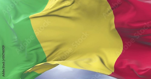 Malian flag waving at wind with blue sky in slow, loop photo