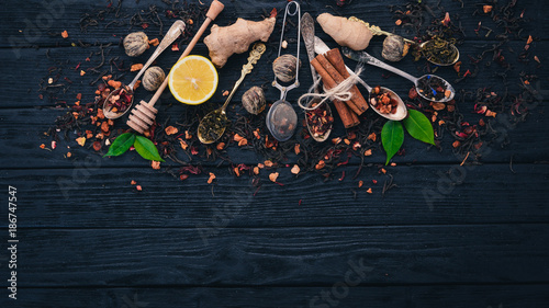 Assortment of dry teas and fragrant herbs and spices. On a wooden background. Top view. Copy space.