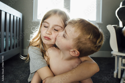 boy kid kissing  shirtless Shirtless boy kissing sister while sitting at home Stock Photo | Adobe Stock