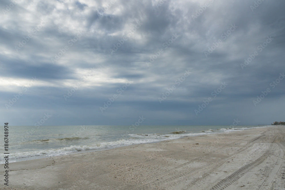 USA, Florida, Endless rough empty white sand beach with cloudy sky near tampa