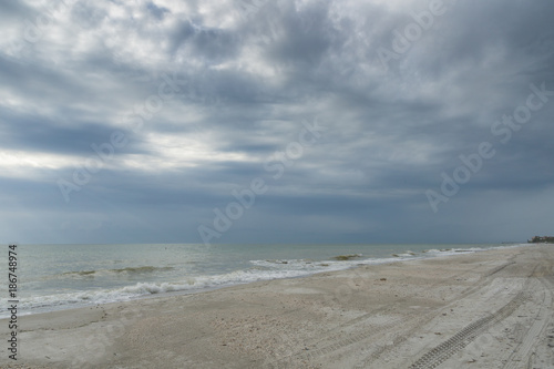 USA  Florida  Endless rough empty white sand beach with cloudy sky near tampa