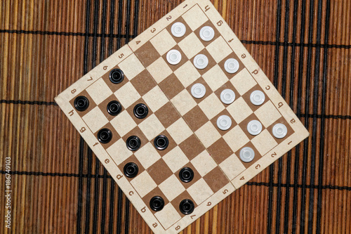 Checkers in checkerboard ready for playing. Game concept. Board game. Hobby. checkers on the playing field for a game. photo