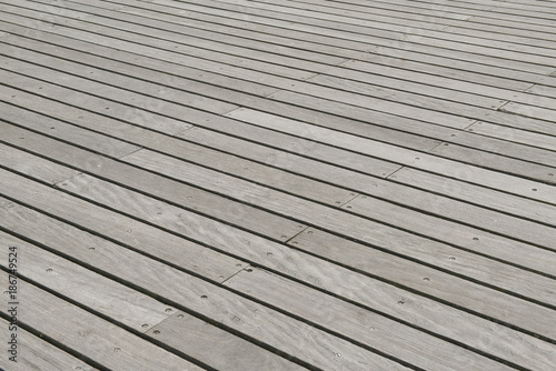 Wooden plank floor of a pier with the lines diagonal
