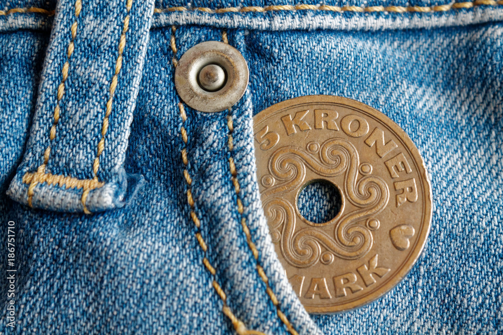Denmark coin denomination is 5 krone (crown) in the pocket of worn light blue denim jeans Denmark coin denomination is 5 krone (crown) in the pocket of worn light blue denim jeans