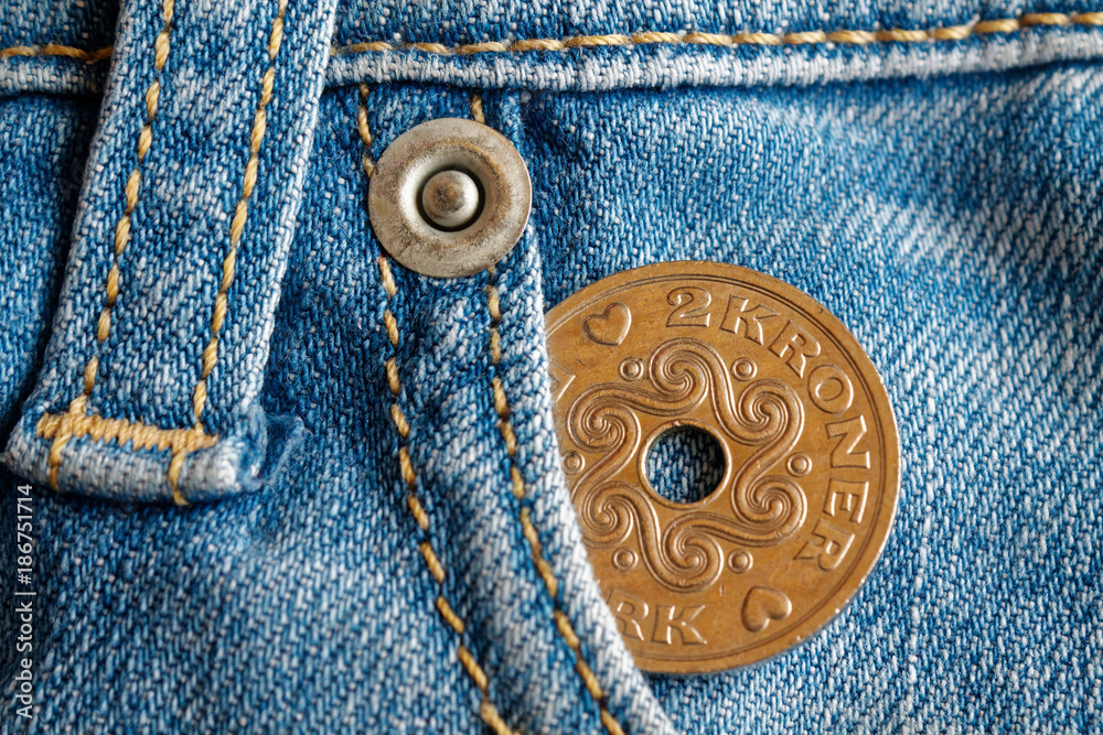 Denmark coin denomination is 2 krone (crown) in the pocket of worn light blue denim jeans Denmark coin denomination is 2 krone (crown) in the pocket of worn light blue denim jeans