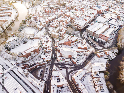 Aerial view of snow covered rail and road networks. Snow, ice and winter weather conditions close railway links and shut roads causing transport delays and dangerous conditions.