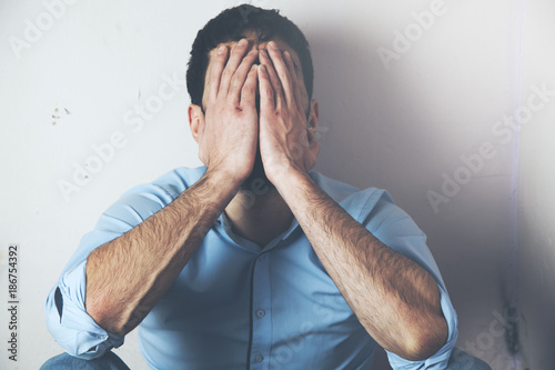 Depressed man hand face