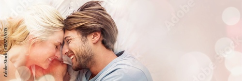 Cute couple relaxing on bed smiling at each other
