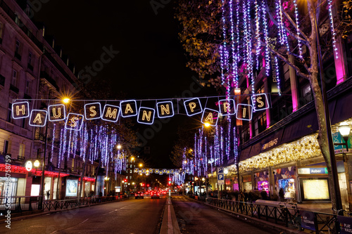 Paris, France - December 4, 2017: Christmas lights on Haussmann boulevard and Parisian department stores