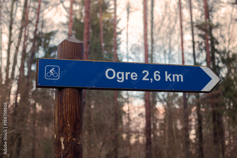 Sign in forest. Signpost - bicycle path on the ogre