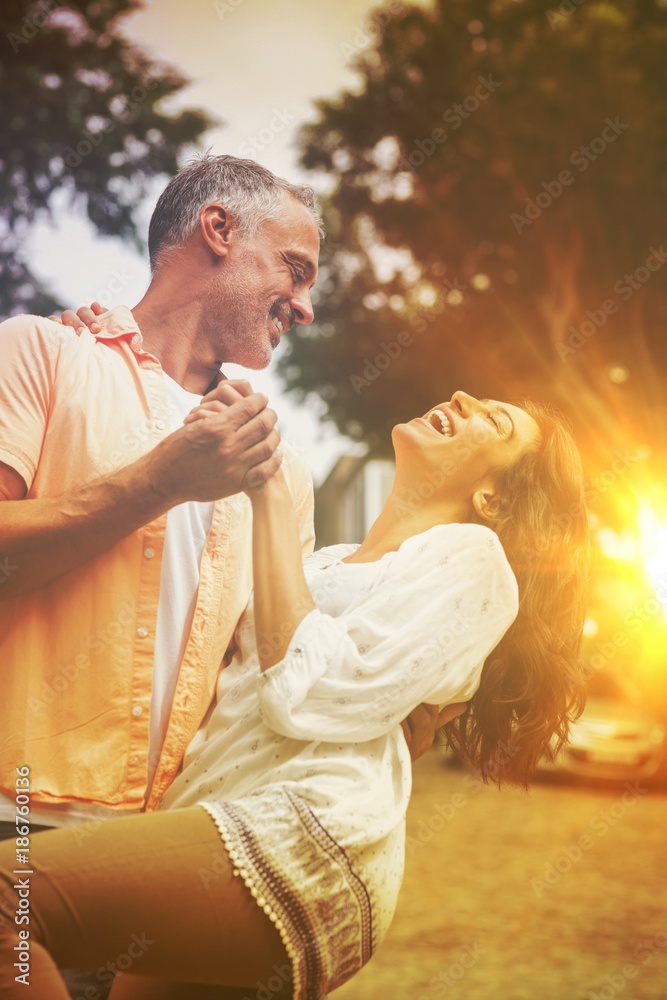 Fotografie Playful couple dancing in city