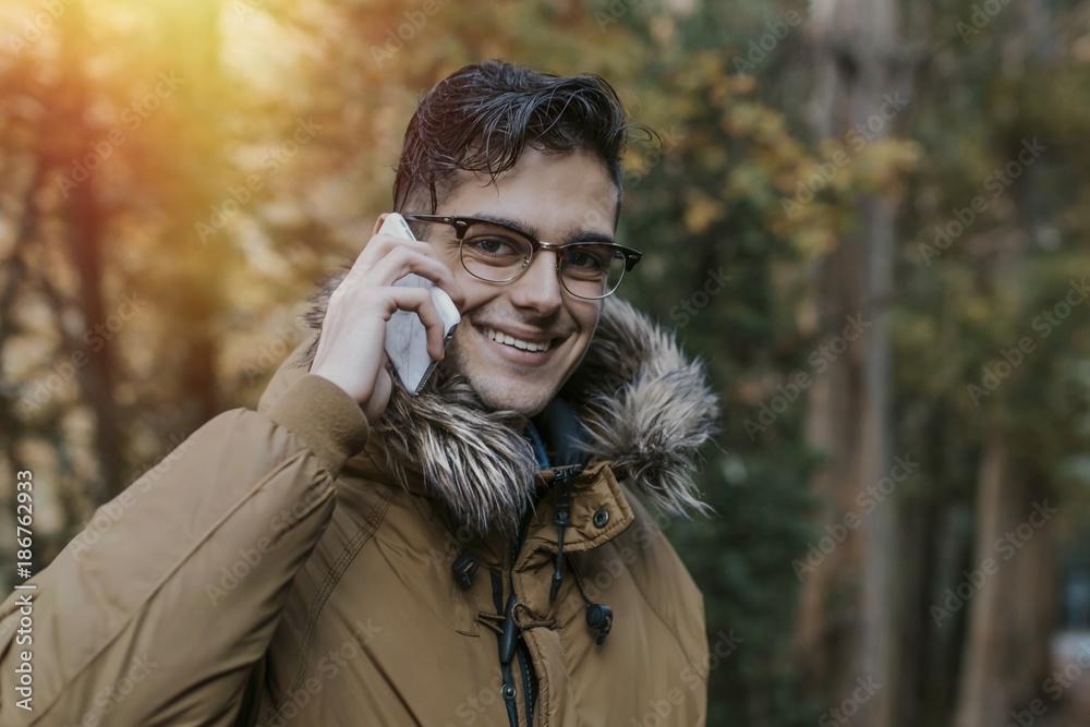 young man with outdoor mobile phone in nature