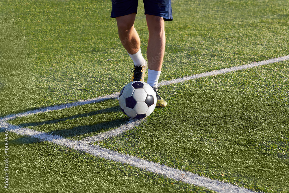 Footballer is preparing to strike a corner kick on the goal. Footballer is preparing to strike a corner kick on the goal.