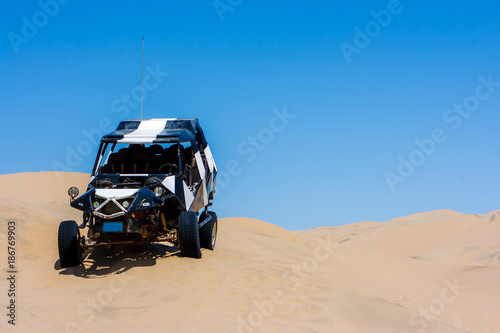 Dune buggy over a sand dune in the desert, Huacachina, Ica, Peru