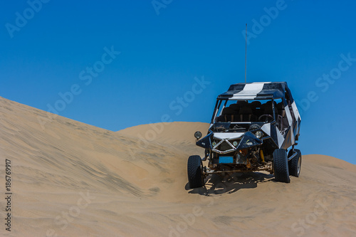 Dune buggy over a sand dune in the desert, Huacachina, Ica, Peru © Giulio