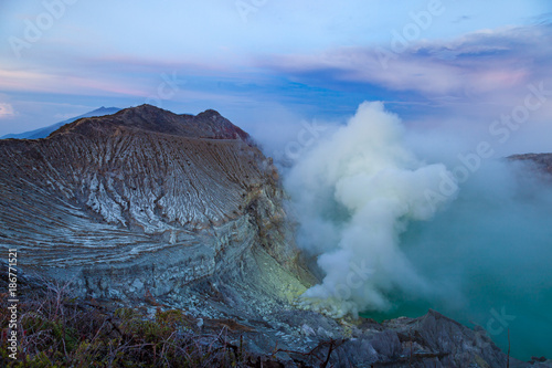 Sunrise at Kawah Ijen volcano crater with sulfur fume. Ijen crater the famous tourist attraction near Banyuwangi, East Java, Indonesia
