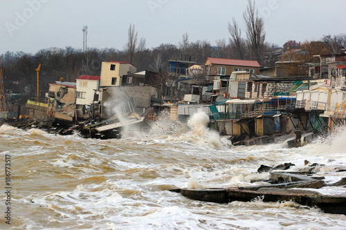 Fototapeta Naklejka Na Ścianę i Meble -  Coastal erosion - houses built on weak clay soil slide down to the sea and collapse