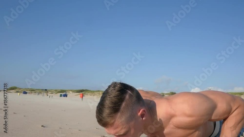 Fit male fitness model working out exercising and doing pull ups