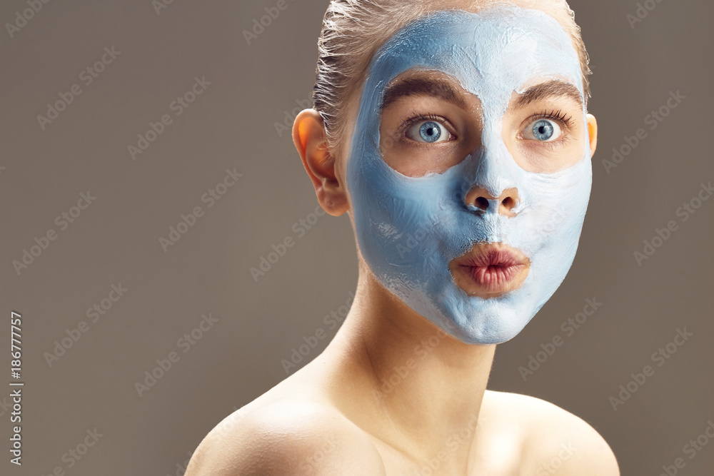 Spa Woman applying mask for face and is surprised Spa Woman applying mask for face and is surprised