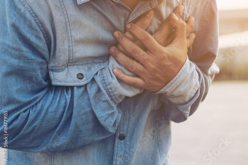 Man having chest pain - heart attack, outdoors selective focus