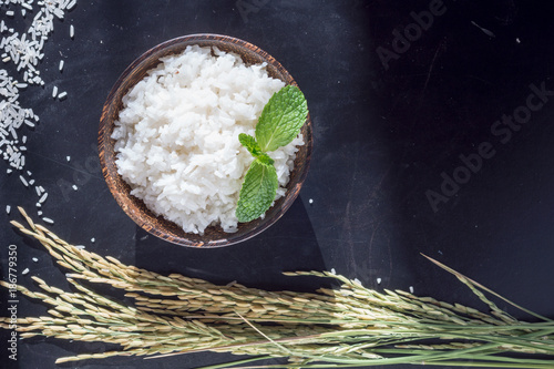 Cooked white rice (Thai Jasmine rice), rice in wooden bowl on dark background,