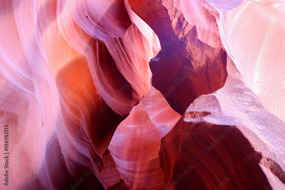 Fototapeta Amazing red sandstone nature background. Swirls of old sandstone wall abstract pattern in red colors in the Upper Antelope Canyon, Page, Arizona, USA.
