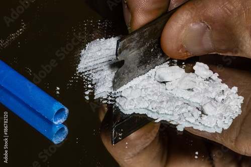 Cutting Cocaine on a Mirror Preparing to Snort