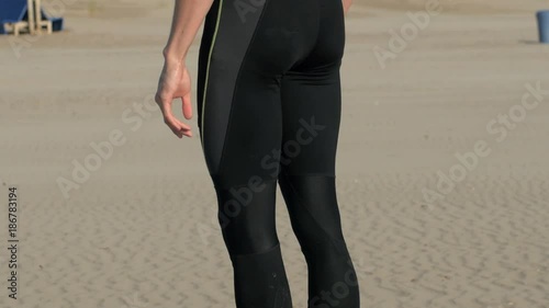 Athletic body muscular man standing on the beac, 4k