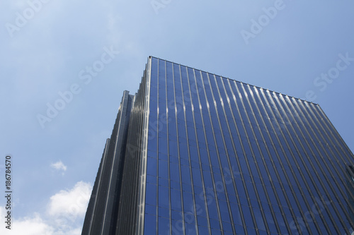 Bottom view of modern, glass skyscraper.