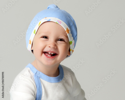 Close up portrait of nfant child baby boy kid toddler in light blue body cloth  and hat  photo