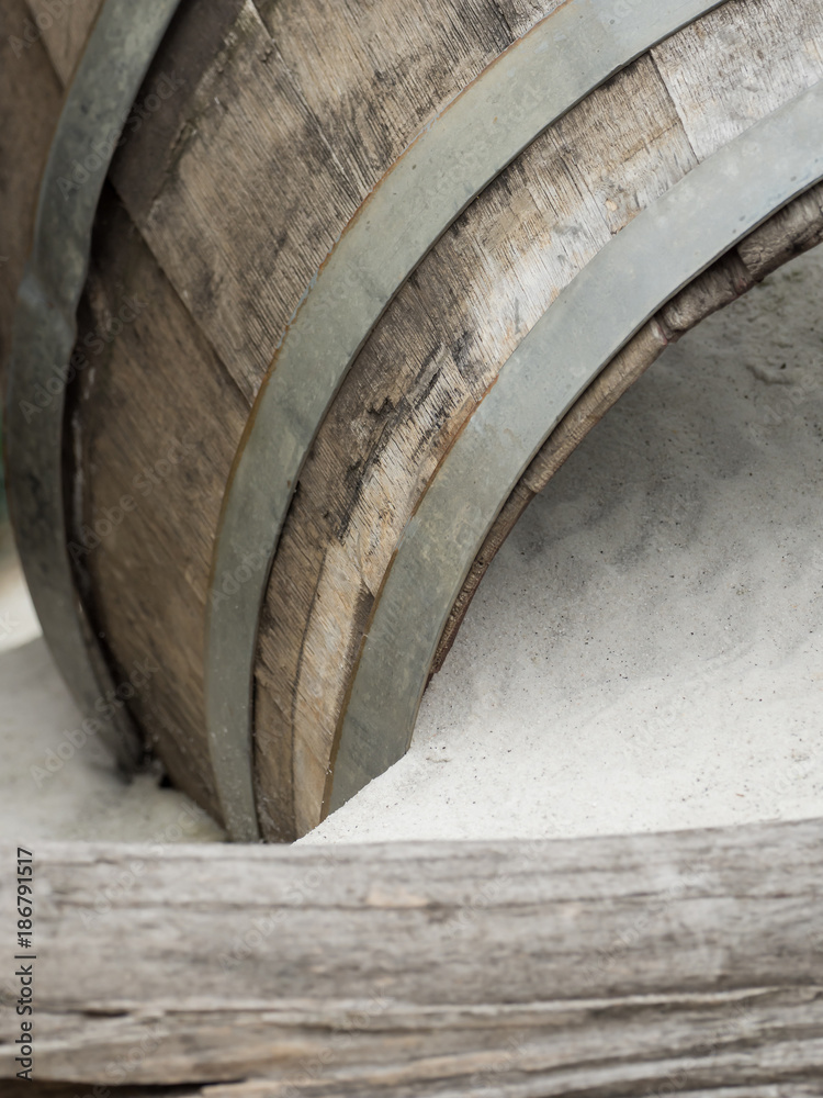 Fototapeta premium An old wooden barrel lies in the sand