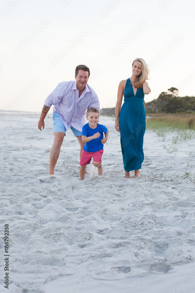 Mom and Dad playing with son on the beach Mom and Dad playing with son on the beach